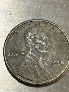 1990 Lincoln penny wrong planchet error showing the coin on a digital scale reading approximately 3.11 grams indicating a pre-1982 bronze planchet